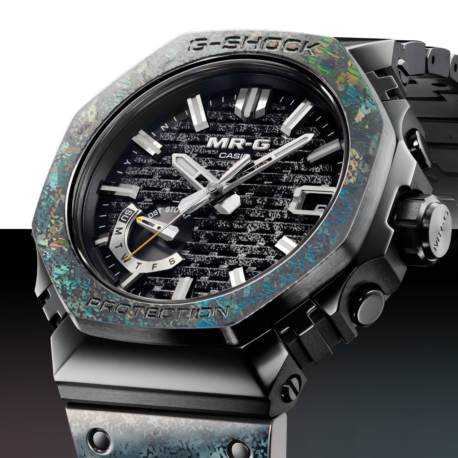 Close-up of the MRG-B2100HR bezel and dial, with iridescent blue, green and gold tones on the bezel