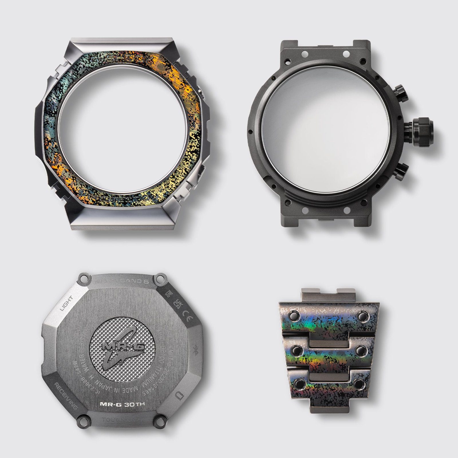 The disassembled MRG-B2100HR case: bezel, case, case back and a bracelet link