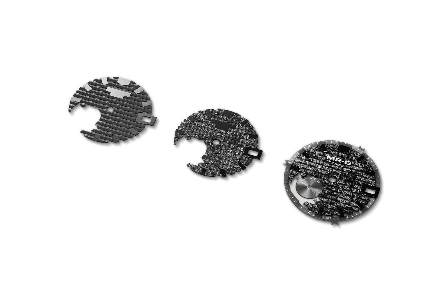 Three MR-G dials at different stages, showing the raised lattice and the platinum leaf finish