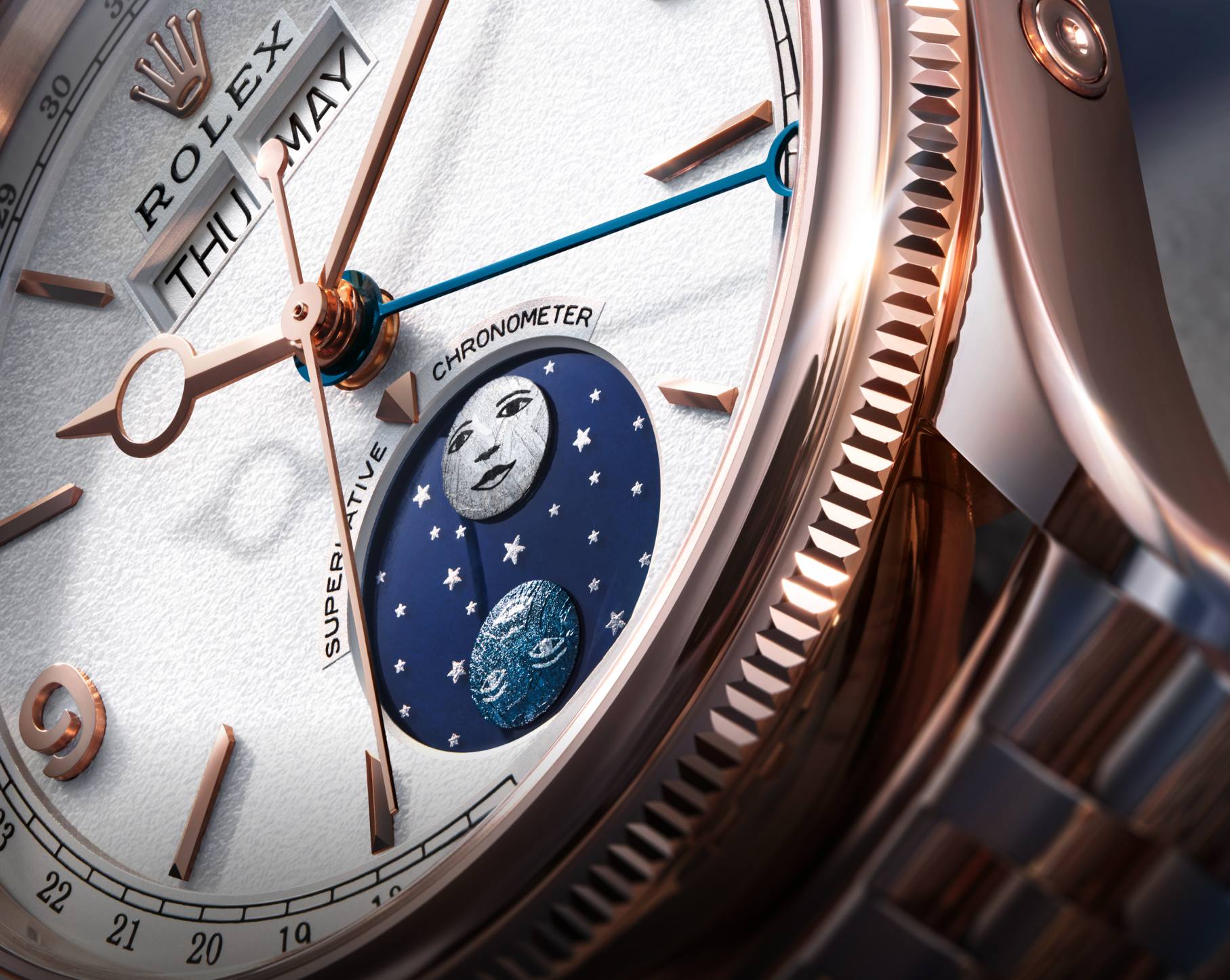 Close-up of the Padellone dial showing the day and month windows, the blue date hand and the blue moonphase disc with its meteorite moons