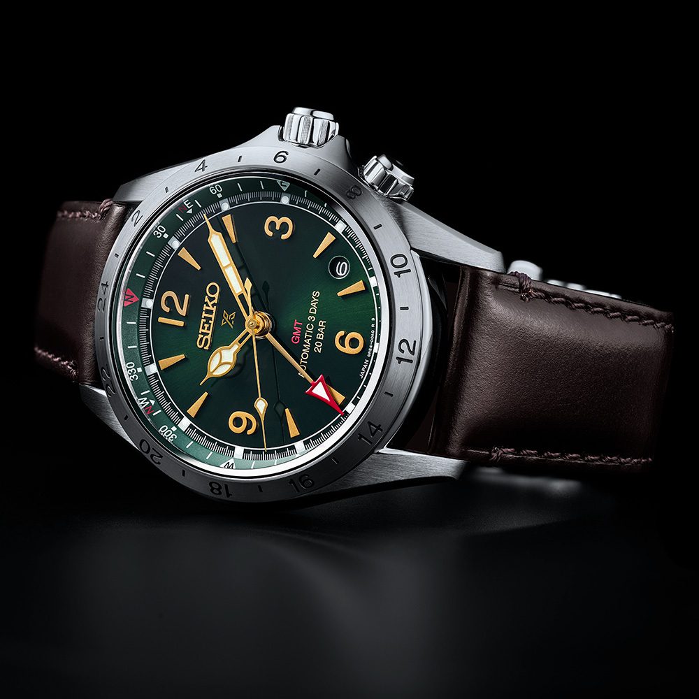 The Seiko Alpinist GMT HBC007 on a black background, lit from the side