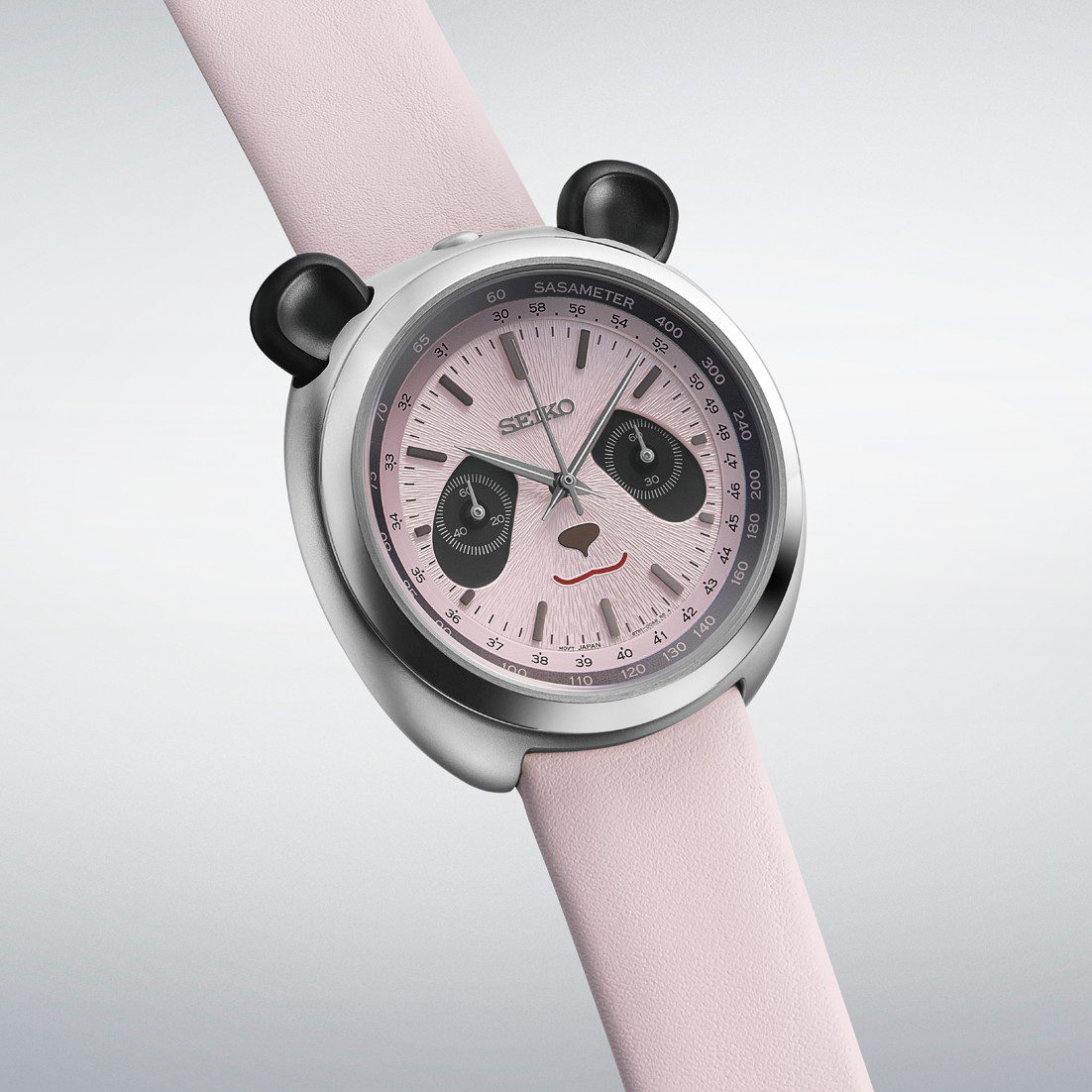 The pink Seiko Panda Chronograph HHK002 on a pink leather strap, seen from an angle